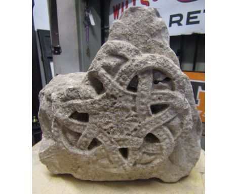 A small carved limestone block with Celtic knot decoration, 25cm max