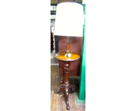 A Victorian mahogany pedestal stand, the turned column and tripod base supporting a circular shelf, later adapted as an elect