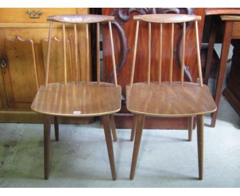 A pair of Danish teak dining/occasional chairs with low stick backs and laminated seats with partially canted detail, raised 