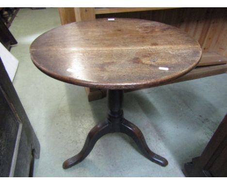 A Georgian tripod table with circular mahogany snap top raised on an oak turned pillar and shaped tripod