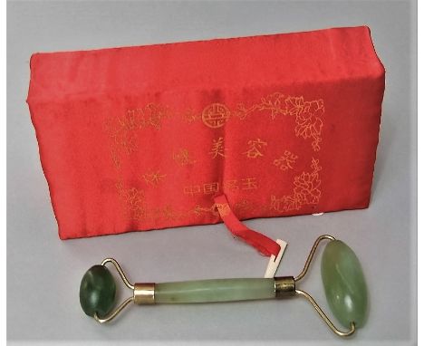 A boxed jade face massager, the box 18 cm long