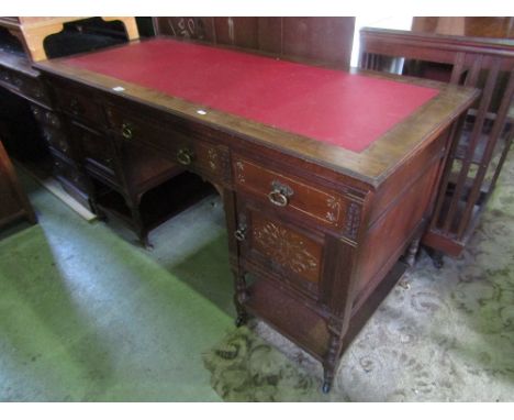 A late Victorian stained oak and walnut writing table of rectangular form fitted with three frieze drawers and two cupboards 