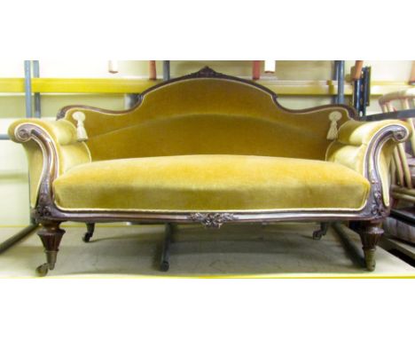 A Victorian drawing room sofa, with carved and moulded framework with floral and other detail, raised on fluted supports, uph