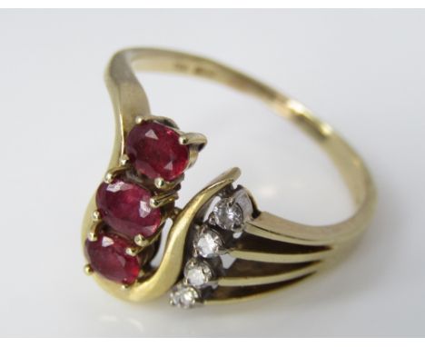 A vintage 14ct ring set with rubies and diamonds in stylised mount, size O, 4.2g