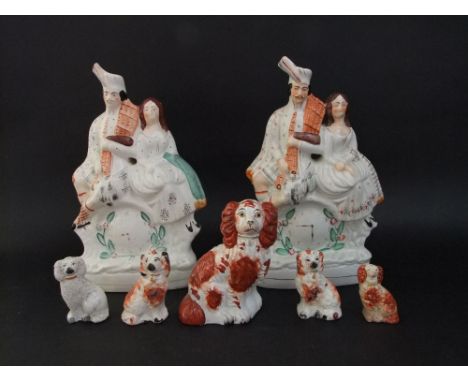 A pair of Staffordshire flat back figures of a piper and his partner over a clock; together with five various Staffordshire h