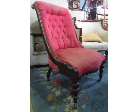 A Victorian drawing room chair with serpentine upholstered seat, scrolled button back and down-swept mahogany showwood frame 