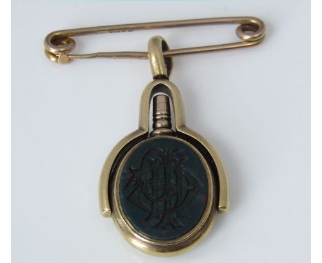 An 18ct swivel watch key fob set with bloodstone monogram and reverse with carnelian intaglio, suspended on a 9ct pin, 12.2g 