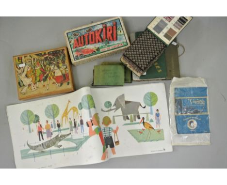 A mixed collection of items including a number of vintage fabric sample books, a French car game, Jeu De Societe, chocolate w