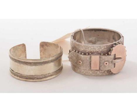A Victorian silver cuff bracelet, the engraved face modelled as a belt or garter, the obverse engraved with a presentation mo
