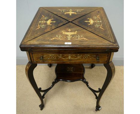 A late 19th Century inlaid rosewood envelope card table, the hinged swivel top opening to reveal a baize lined playing surfac