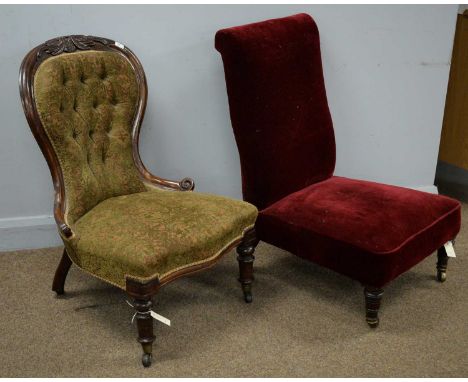 A Victorian carved walnut and button upholstered balloon back easy chair; and an Edwardian low easy chair, upholstered in a b