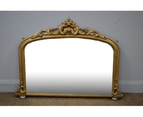 A gold painted overmantel mirror probably late 19th/early 20th Century, with leaf pattern ornamentation on ceramic feet, 108 
