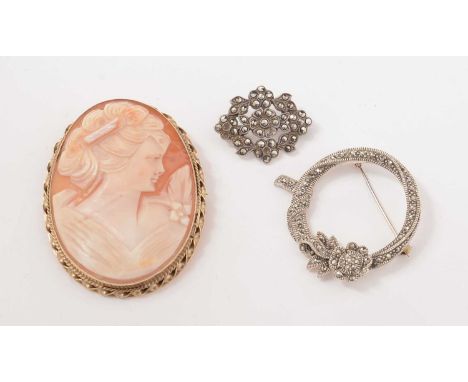 A 9ct gold and carved shell cameo brooch, depicting the profile portrait of a young lady; and two white metal and marcasite b