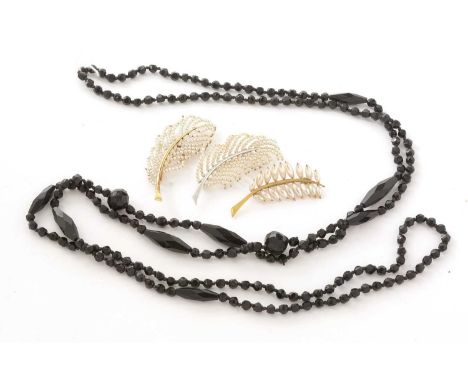 Cultured seed pearl feather pattern brooches, and a faux jet necklace.