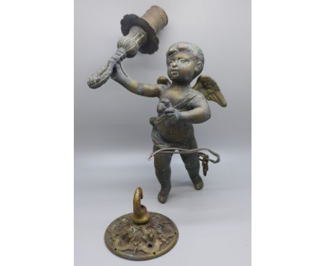 A cherub brass ceiling light with hook 