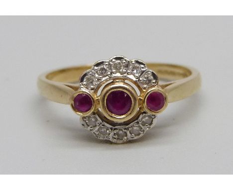 A 14ct gold, three stone ruby and diamond cluster ring, 3.6g, S 