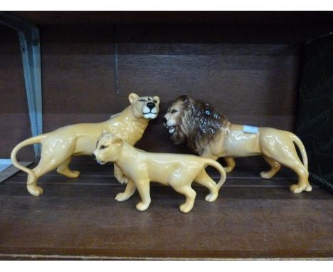 A Beswick lion, lioness and cub ceramic figures 