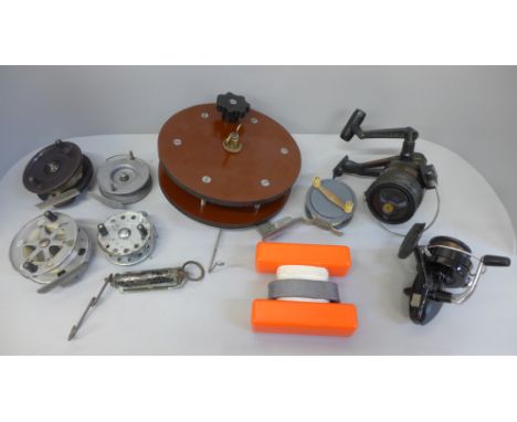 A collection of fishing reels (7) and a spring balance scale 