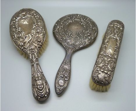 Two silver backed brushes and a silver backed mirror 