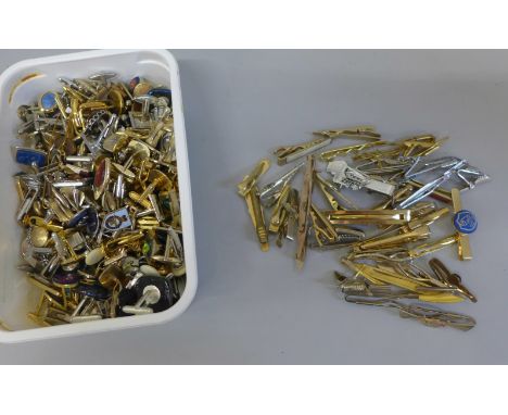 Over eighty pairs of cufflinks and a collection of tie pins 
