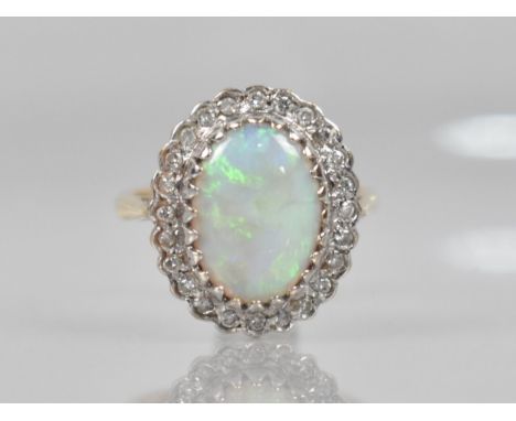 An Opal and Diamond Ladies Dress Ring in 9ct Gold, Central Oval Low Cabochon Opal Measuring 13.7mm by 10.3mm Approx, Raised i