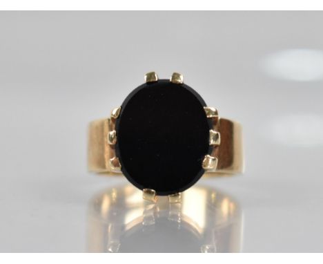 A Onyx and 9ct Gold Signet Ring, Oval Onyx Panel Measuring 14mm by 12.2mm Diameter Raised in Ten Wide Claws to a Flattened Po