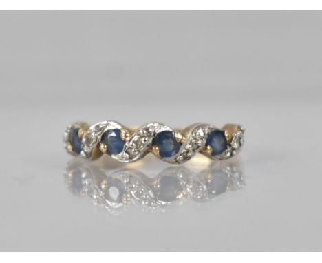 A Sapphire and Diamond 9ct Gold Ladies Dress Ring, Four Round Cut Sapphires Claw and Tension Set in Yellow and White Metal wi