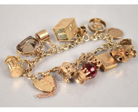 A 9ct Gold Charm Bracelet, 12 Gold Metal Charms, Most Stamped for 9ct, to include Vespa, Lamp, Tankard, Smokey Quartz Fob, Ga