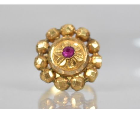 An Indian Gold Coloured Metal and Ruby Ring, Central Ruby Measuring 3.6mm by 3.0mm in a Raised Crimped Collet Mount, Repousse