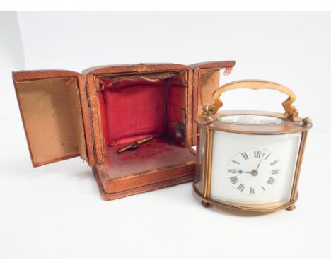 Oval Edwardian carriage style clock in fitted case with key size with handle up 12cm 