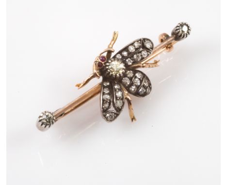 Diamond set bumble bee bar brooch, naturalistically modelled with diamonds inset to the body and wings, with ruby eyes, mount