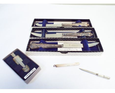 3 silver handled cased knives, silver bookmark with owl motif, and a silver paper knife in engine turned case 