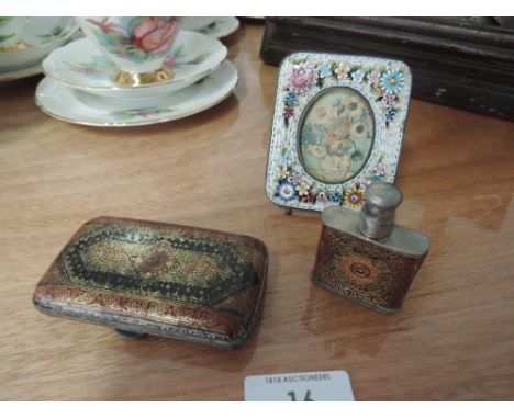 An enamelled cigarette case, a small enamelled lighter fuel container and decorative photo frame. 