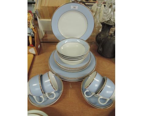 A part tea service by Doulton in baby blue and guilt