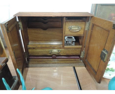 An oak desk tidy with drawers and letter rack