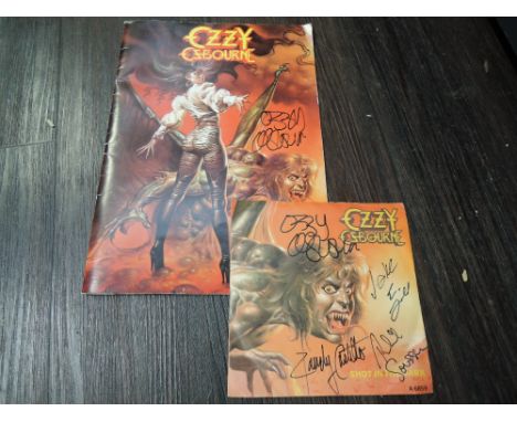 A copy of Ozzy Osbourne The Ultimate Sin Tour guide and Shot in the Dark 45rpm single signed by Ozzy and band a genuine item 