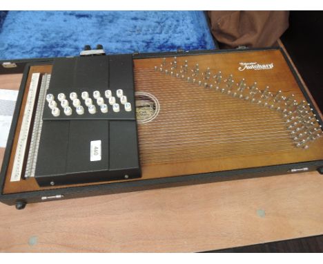An Oscar Schmidt Educator auto harp, model OS-30C serial number 19745, fitted with pick up and hard case