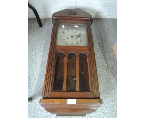 A stained frame wall clock.