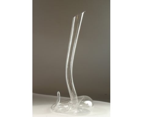 A GLASS CARAFE by RIEDEL, shaped like a snake. 51cms high.