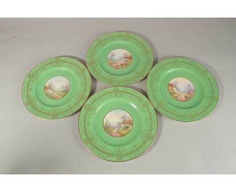 A SET OF FOUR ROYAL WORCESTER CIRCULAR GREEN PLATES the centres painted with a college and flowers, signed. 25cm diameter.