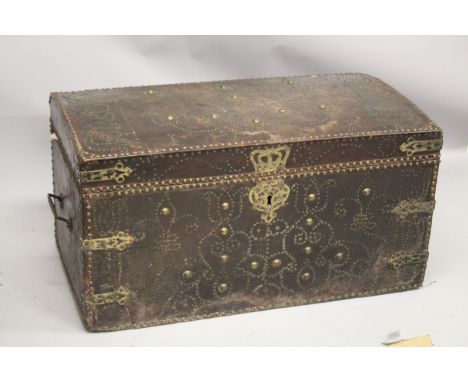 A GOOD 18TH CENTURY BRASS STUDDED LEATHER DOME TOP TRUNK, with wrought iron carrying handles, dated 1713. 3ft 6ins wide x 2ft