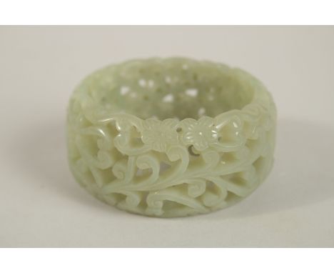 A GOOD PIERCED CELADON BANGLE. 7cms diameter.