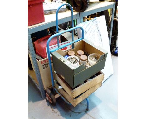 Three boxes of mixed tools including bolts and screws and an industrial trolley