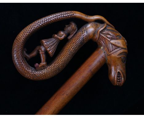 Late 19th Century Metsovo region walking stick, with a figure in traditional Greek costume walking along a serpents tail, the