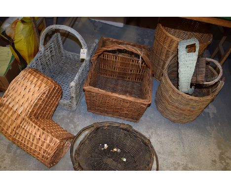 A wicker staircase basket; a rectangular wicker hamper basket with space for three bottles; a wicker log basket; etc.  (8)