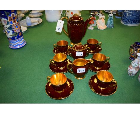 A Carlton ware 'Rouge Royale' coffee set for six, comprising; coffee pot, cream jug and six cans and saucers.