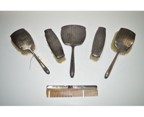 A silver dressing table set, to include: hand mirror, two hand brushes, two clothes brushes, and a comb, by W.G. Sothers Ltd.