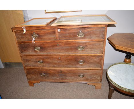 A late Georgian mahogany chest of two short and three long drawers with brass handles, raised on bracket feet.