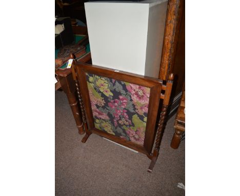 A mahogany framed fire screen, the glazed insert set with printed floral material, 88cms high.