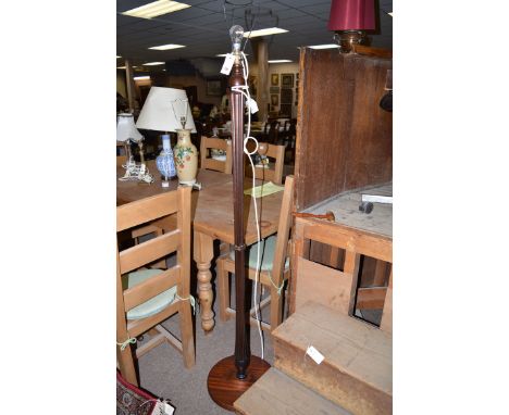 A modern mahogany standard lamp with reeded column on circular base.